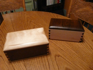 A pair of almost-matching jewelry boxes.